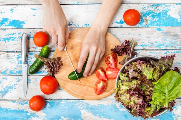 Hands preparing salad